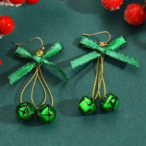 Festive Christmas earrings featuring green bowknots and jingle bells on gold-tone hooks