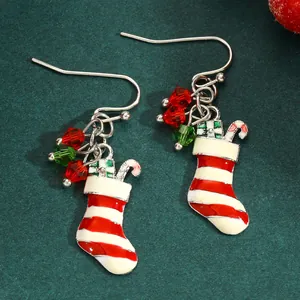 Macro detail of festive red and white striped Christmas stocking enamel dangle earrings