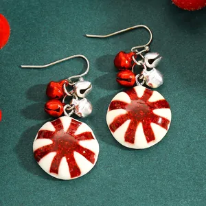 Detailed view of festive peppermint candy earrings with red and silver jingle bells.