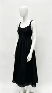 Elegant black French style maxi dress with thin straps and button details on mannequin