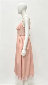 Detail side view of a French style pink backless maxi dress with ruffled straps.