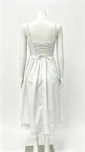 Back view of a French style white maxi dress with lace-up backless design on mannequin.