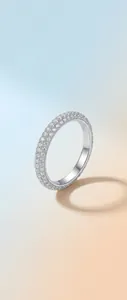 Close-up view of an S925 sterling silver moissanite ring with sparkling pave setting.