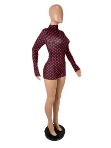 Detail of sexy long-sleeved slim fit jumpsuit with red and black polka dot pattern