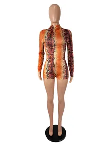 Detailed view of the orange snake print pattern on this long sleeve slim fit romper.