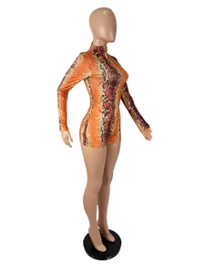 Full side view of a vibrant orange snakeskin print long sleeve bodysuit on mannequin