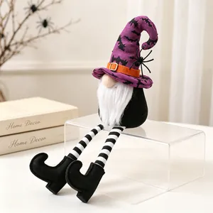 Close-up of a Halloween gnome with a purple bat-patterned hat and long striped legs.