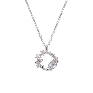 Dreamy planet necklace with zirconia flowers and moonstone-like pendant on silver chain