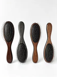 Close-up of four professional massage hairbrushes with various wood grain and patterns