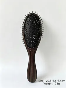 Detail of portable air cushion massage comb with silver needle teeth and wood grain handle