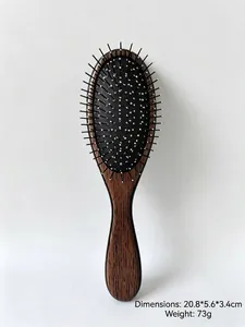 Close-up detail of wooden texture hairbrush featuring silver-colored metal massage bristles