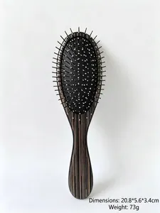 Detailed view of portable air cushion hairbrush with silver needle teeth and wood texture