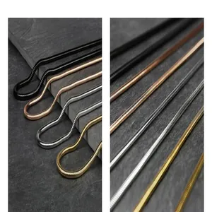 Close-up detail of titanium steel snake bone chains in gold, silver, and black finish.