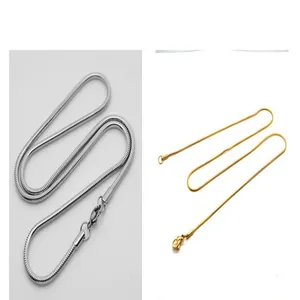 Detailed view of silver and gold titanium steel snake bone chains with lobster clasps.