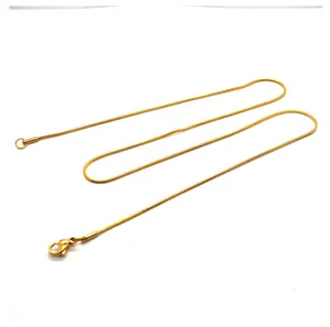 Close-up detail of a minimalist 18K gold plated titanium steel snake bone chain necklace