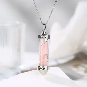 Close-up detail of a hexagonal silver pendant filled with pink rose quartz and Love engraving
