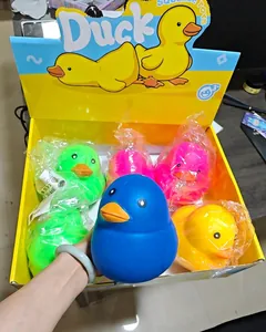 Handheld close-up view of a large blue flour-filled duck squeeze toy in display box