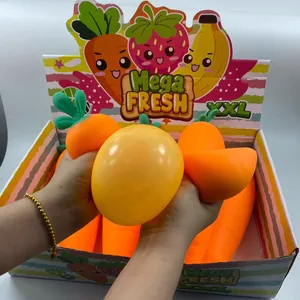 Close-up of giant carrot-shaped flour-filled stress relief squeeze toy being squeezed by hands.