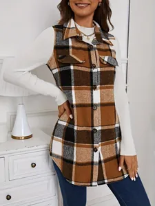 Close-up of a brown and black plaid sleeveless vest over a white long-sleeved ribbed top.