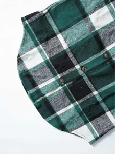 Close-up of green and black plaid fabric detail on women's sleeveless wool vest