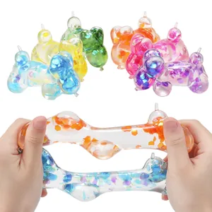 Macro view showing stretchy balloon dog squishy toy with colorful glitter flakes.