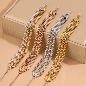 Macro view of multi-strand stainless steel bracelets in gold, silver and rose gold finishes
