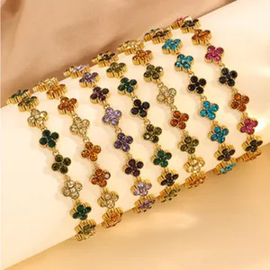Close-up of heart-shaped clover bracelets with multi-colored crystals and gold finish