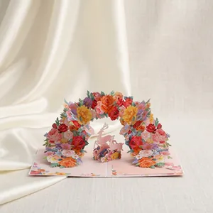 Gedetailleerde weergave van de bloemenboog en roze herten op de 3D pop-up wenskaart