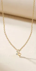 Detailed macro view of a 925 silver gold-plated heart necklace with moissanite stone accent