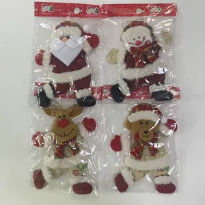 Detailed view of four festive Christmas plush hanging ornaments in individual packaging
