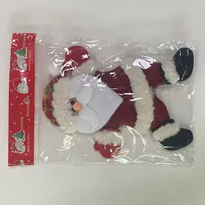 Handcrafted Santa Claus fabric doll ornament inside a clear plastic retail packaging