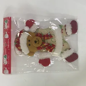 Detailed view of a burlap Christmas bear ornament in its original retail packaging