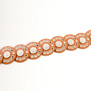 Detailed view of the ethnic style brown leather wide belt with silver metal eyelets.