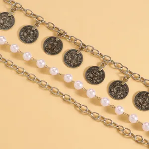 Close-up of Bohemian multi-layer waist chain with coin charms and faux pearls