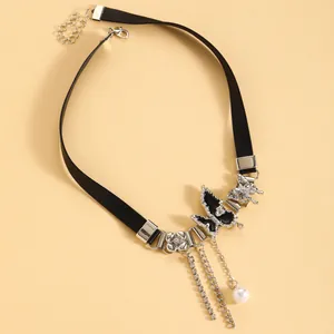 Detail view of Y2K style butterfly leather choker with silver chains and pearl