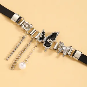 Detailed macro shot of Y2K gothic butterfly leather choker with silver chains and pearl
