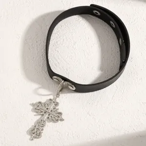 Detailed view of Gothic Y2K black leather choker with ornate silver cross pendant