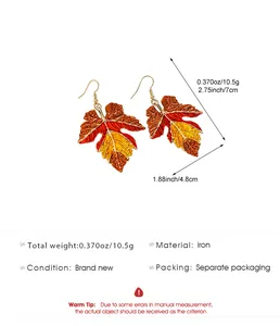 Detail view of colorful autumn maple leaf earrings with size and weight specifications.