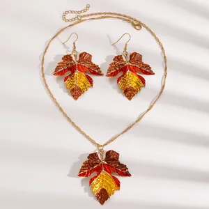 Detail of vintage colorful maple leaf necklace and earring set in autumn colors.