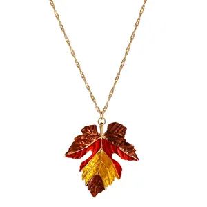 Detail of autumn maple leaf pendant necklace with retro red and yellow gradient finish.