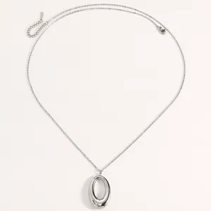 Close-up view of a polished silver titanium steel necklace with an elegant oval pendant