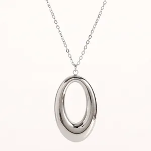 Detailed view of minimalist silver oval horseshoe pendant necklace in polished titanium steel