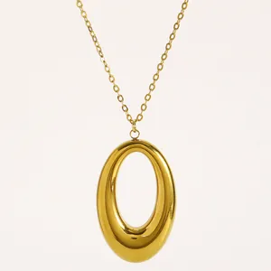 Close-up of polished gold-plated oval pendant on fine titanium steel chain