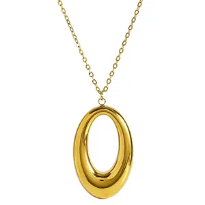 Close-up detail of the smooth polished gold horseshoe pendant necklace for women.