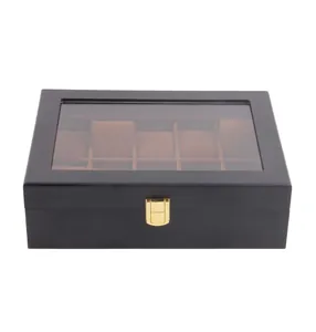 Closed black lacquered wooden watch box with gold latch and transparent lid.