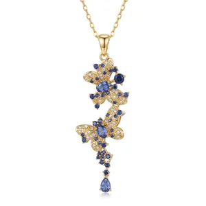 Detailed view of elegant gold butterfly pendant necklace with blue and white zircon stones