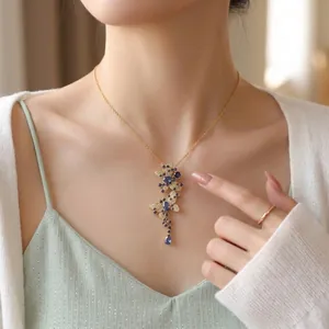 Elegant blue butterfly pendant necklace with shimmering micro-pave zircon on a gold chain