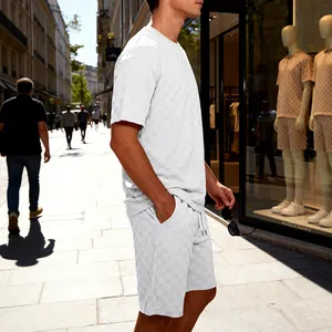 Detailweergave van witte herenset met dambord jacquard textuur op shirt en short