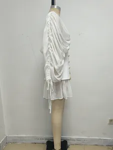 Vista lateral de un vestido corto blanco de malla con mangas plisadas y cordones finos