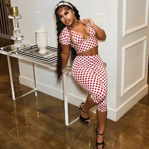 Detail view of a sexy red polka dot three-piece set featuring a crop top and leggings.